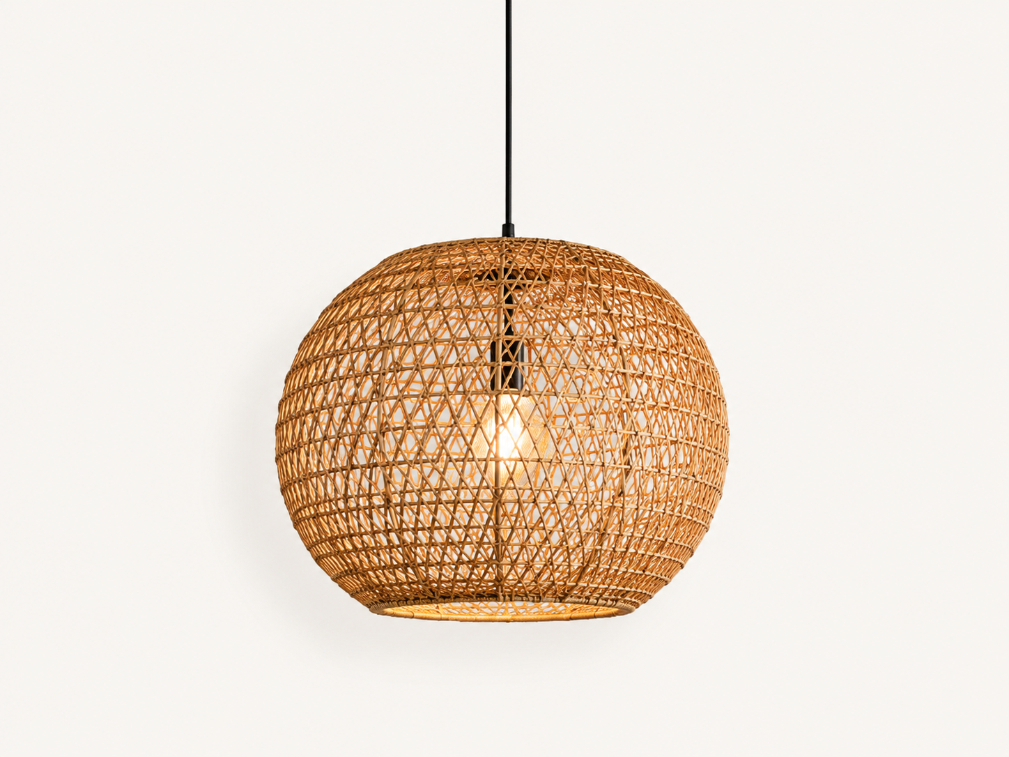 Close-up of a rattan orb pendant light showing open woven lattice shade with warm glowing bulb visible through the weave