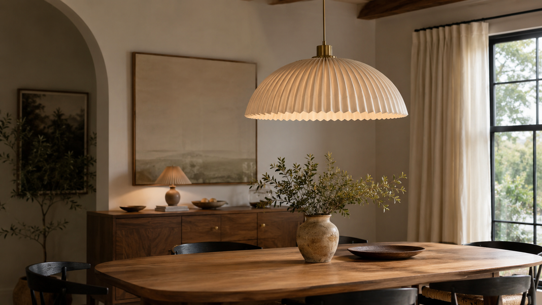 Warm modern dining room with a pleated dome pendant light hanging above a wood table
