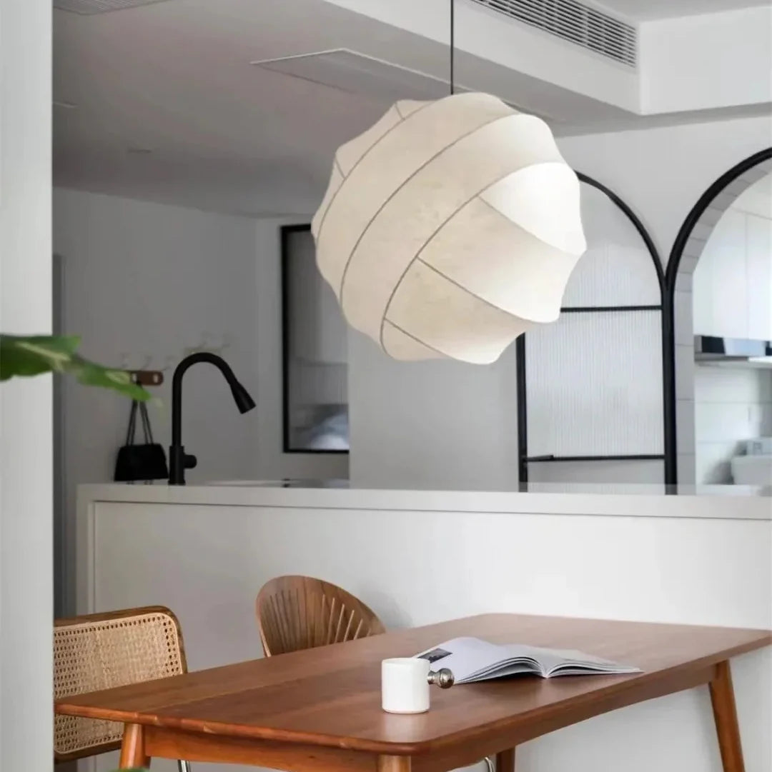 Luma silk pendant light with off-white pleated fabric shade and illuminated diffuser
