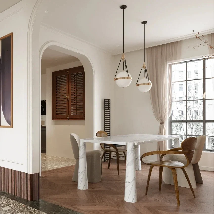 Set of three globe pendant lights with white glass shades, black cords, and gold trim