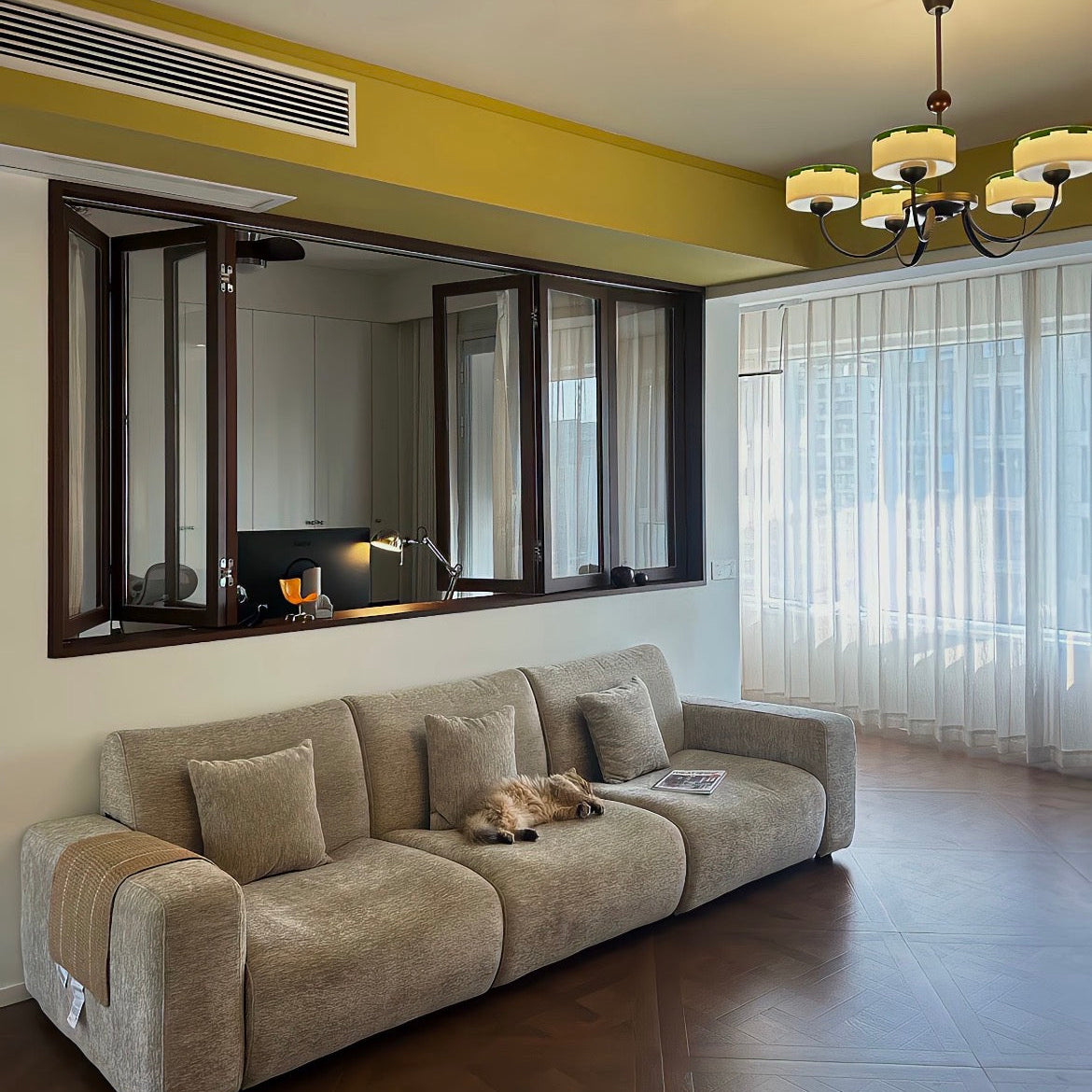 Multi-arm ceiling chandelier with several opal glass shades and dark metal frame