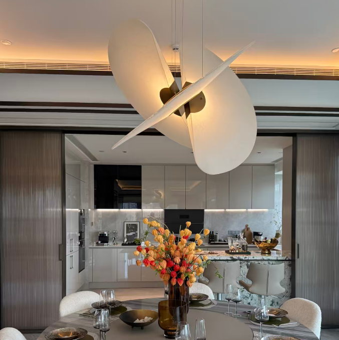 Butterfly pendant light with large white dome shade and crossed blades with warm glow