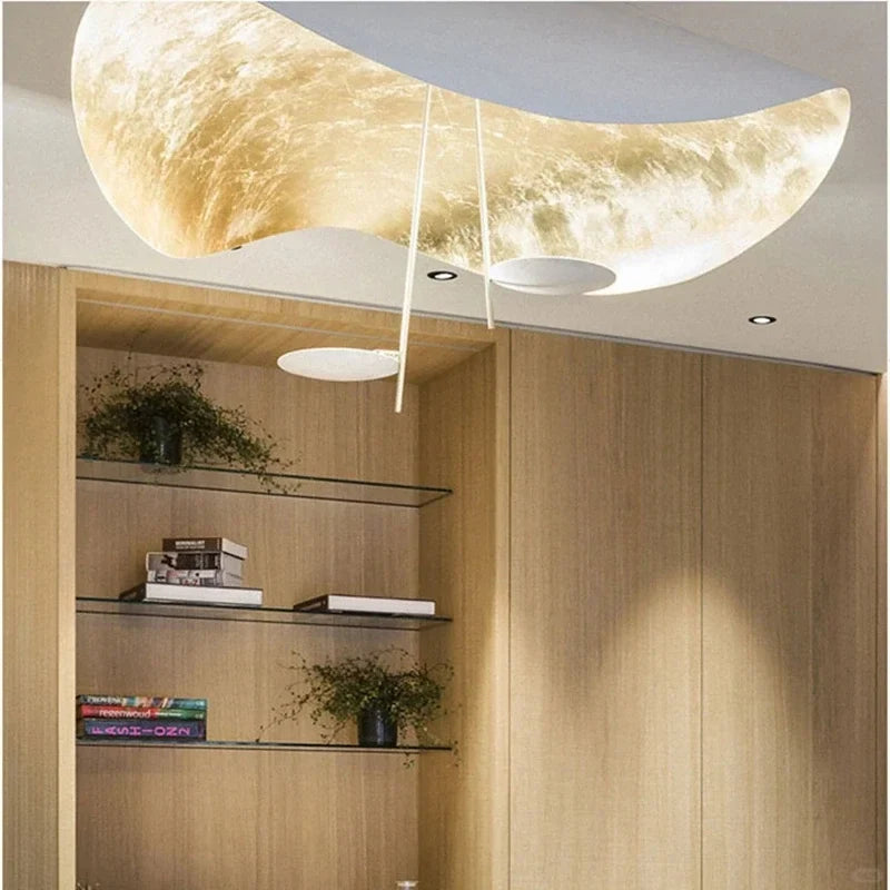 Gold foil and black disc pendant light with curved, textured metal shade underside