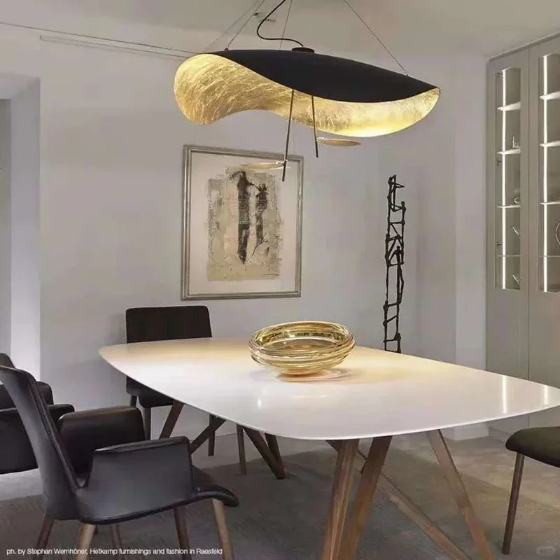 Gold foil and black pendant light with curved disc canopy and hanging cord