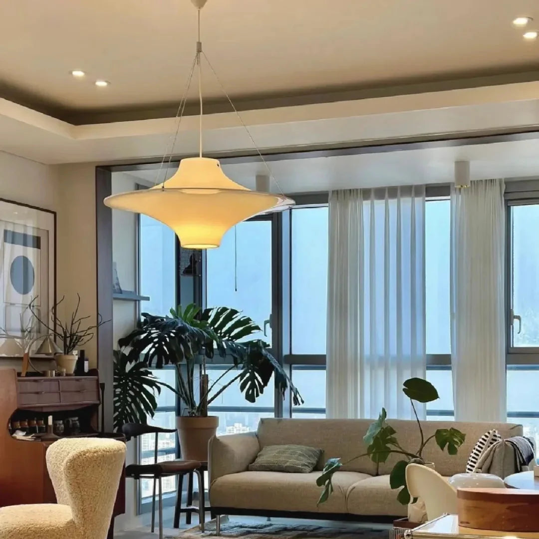White opal disc pendant light hanging from ceiling with slender cord