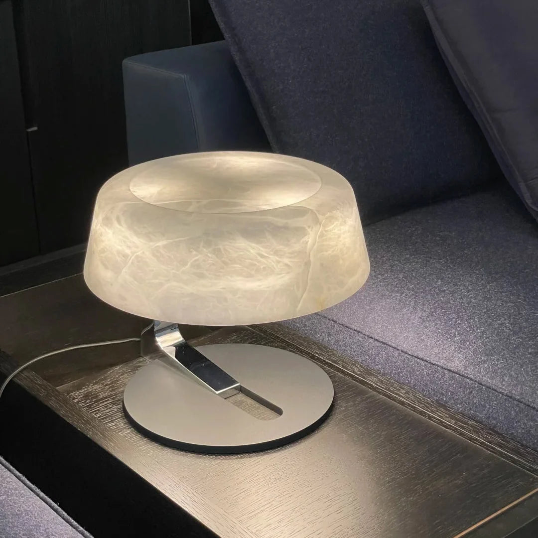 Alabaster table lamp with frosted round shade and brushed metal arm on black base