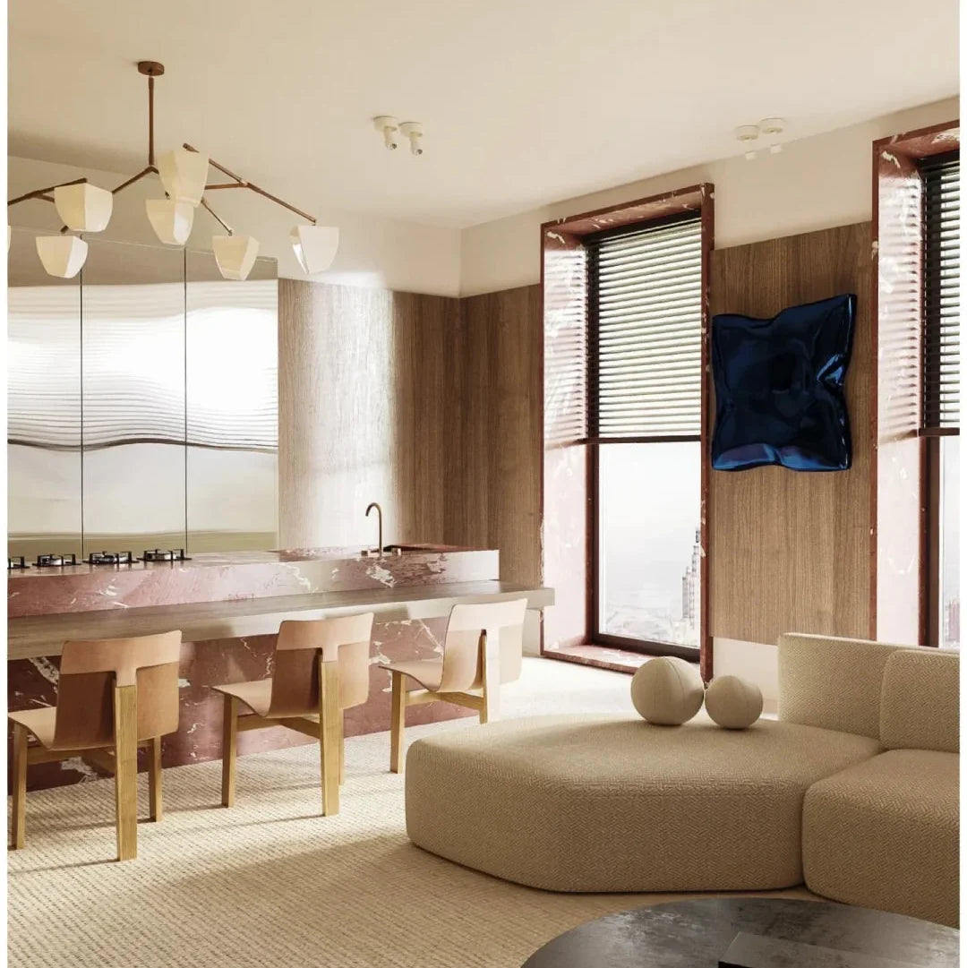 Brass branching chandelier with off-white cone shades over a living room seating area