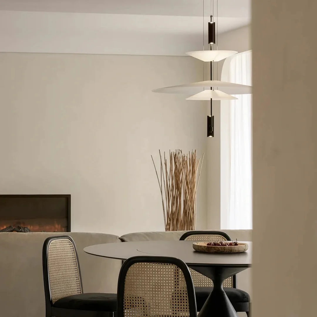 Stacked disc chandelier with white shades and black suspension rods