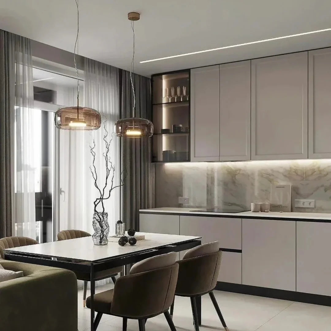 Multiple glass dome pendant lights with brass caps and warm exposed bulbs