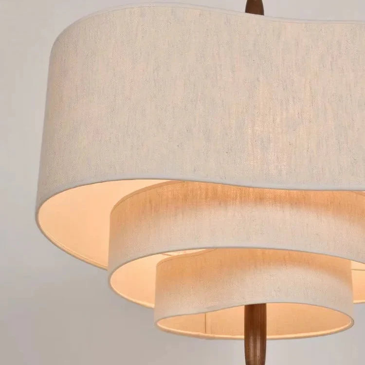 Close-up of layered beige linen pendant light drum shades