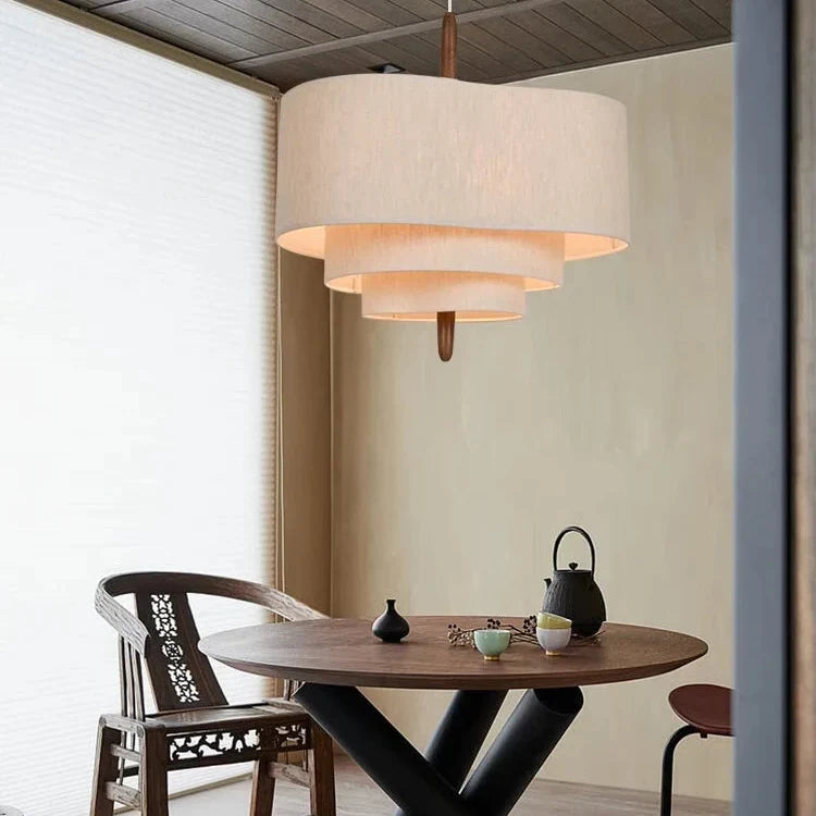 Beige layered linen pendant light with multiple drum shade tiers