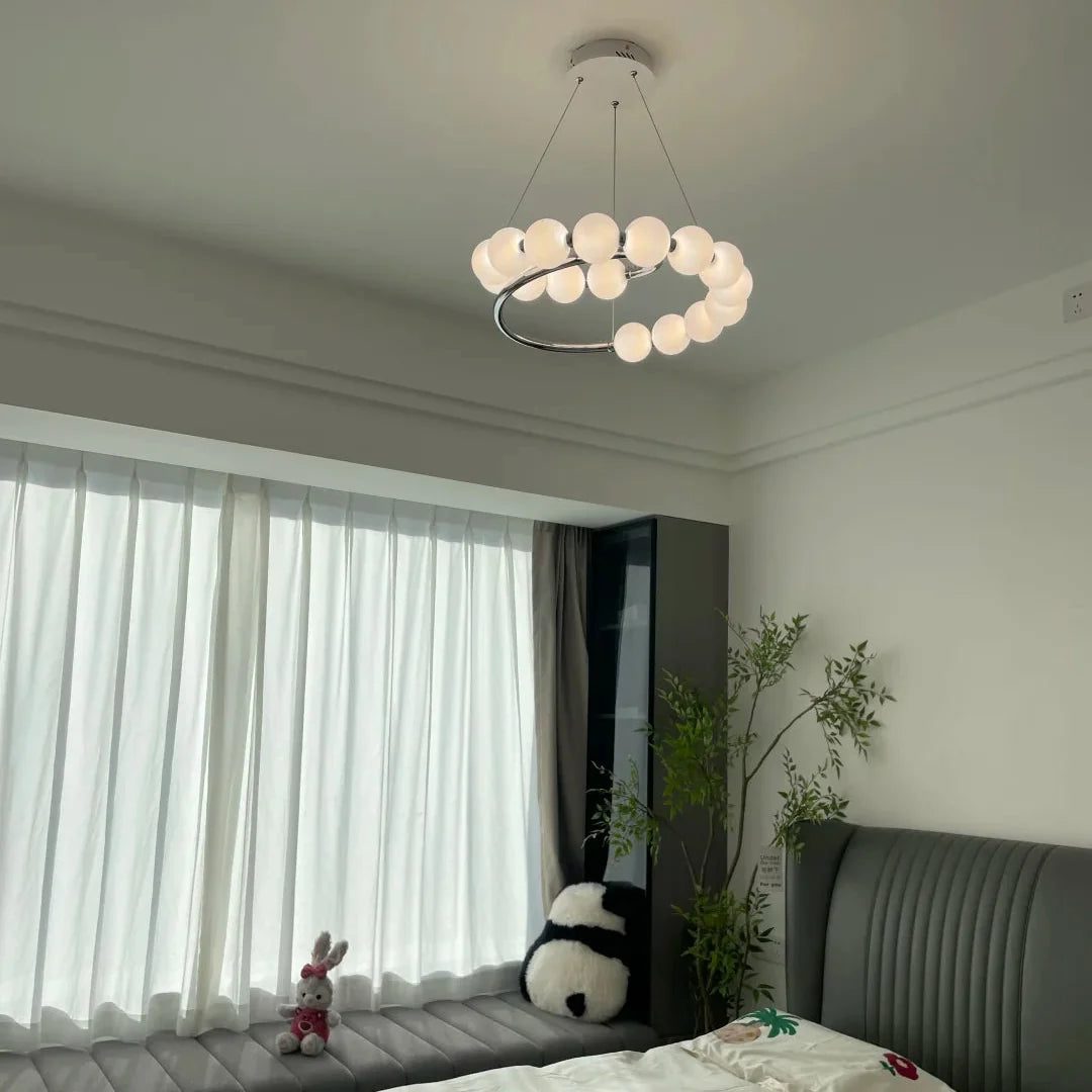 Spiral pearl chandelier with frosted white globe shades and a chrome ring center bar