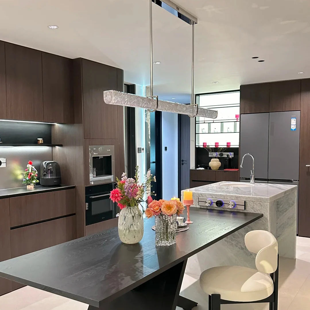 Linear pendant light with textured glass tube and suspended chrome supports