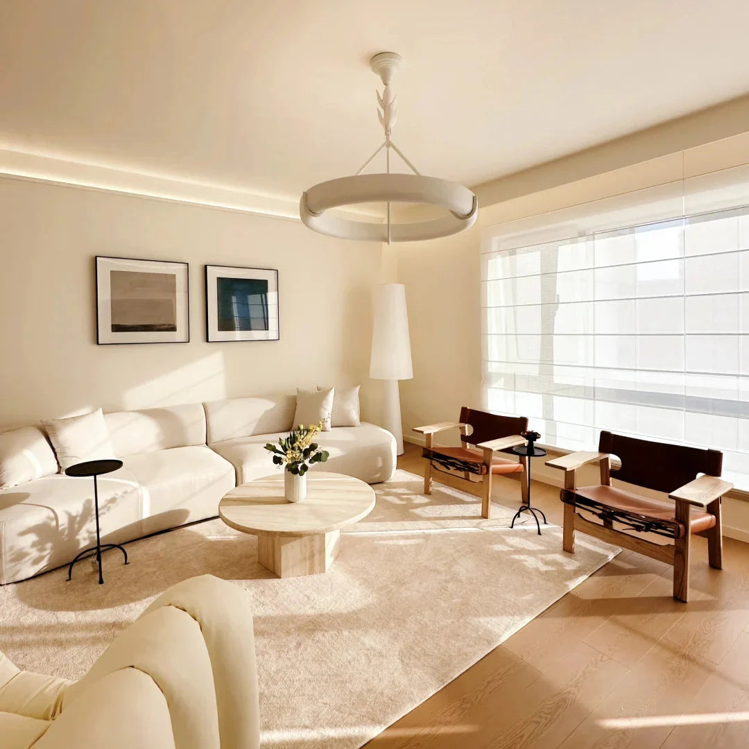White circular ceiling chandelier with branching stem and curved shade ring