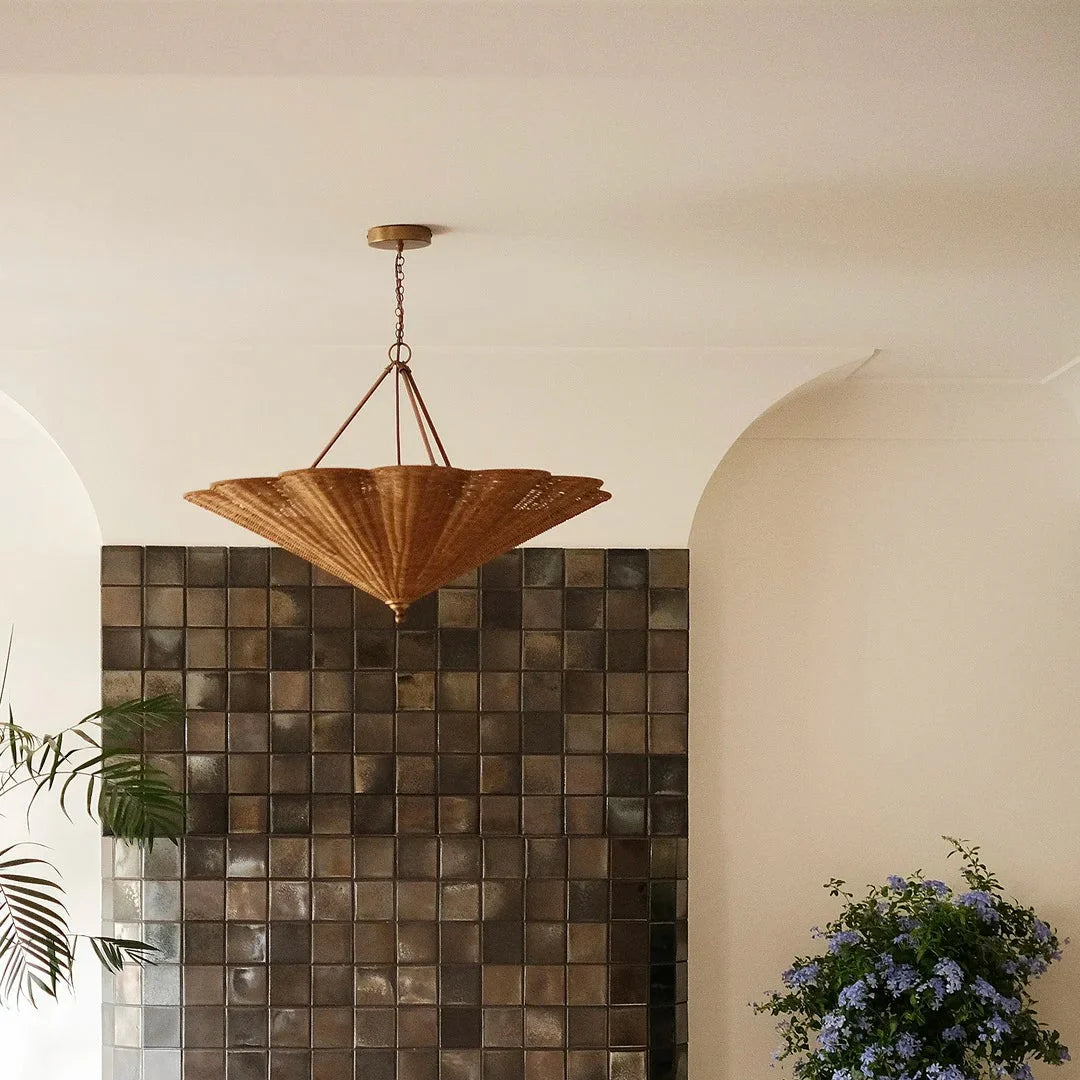 Rattan umbrella pendant light with woven shade and brass ceiling canopy, suspended