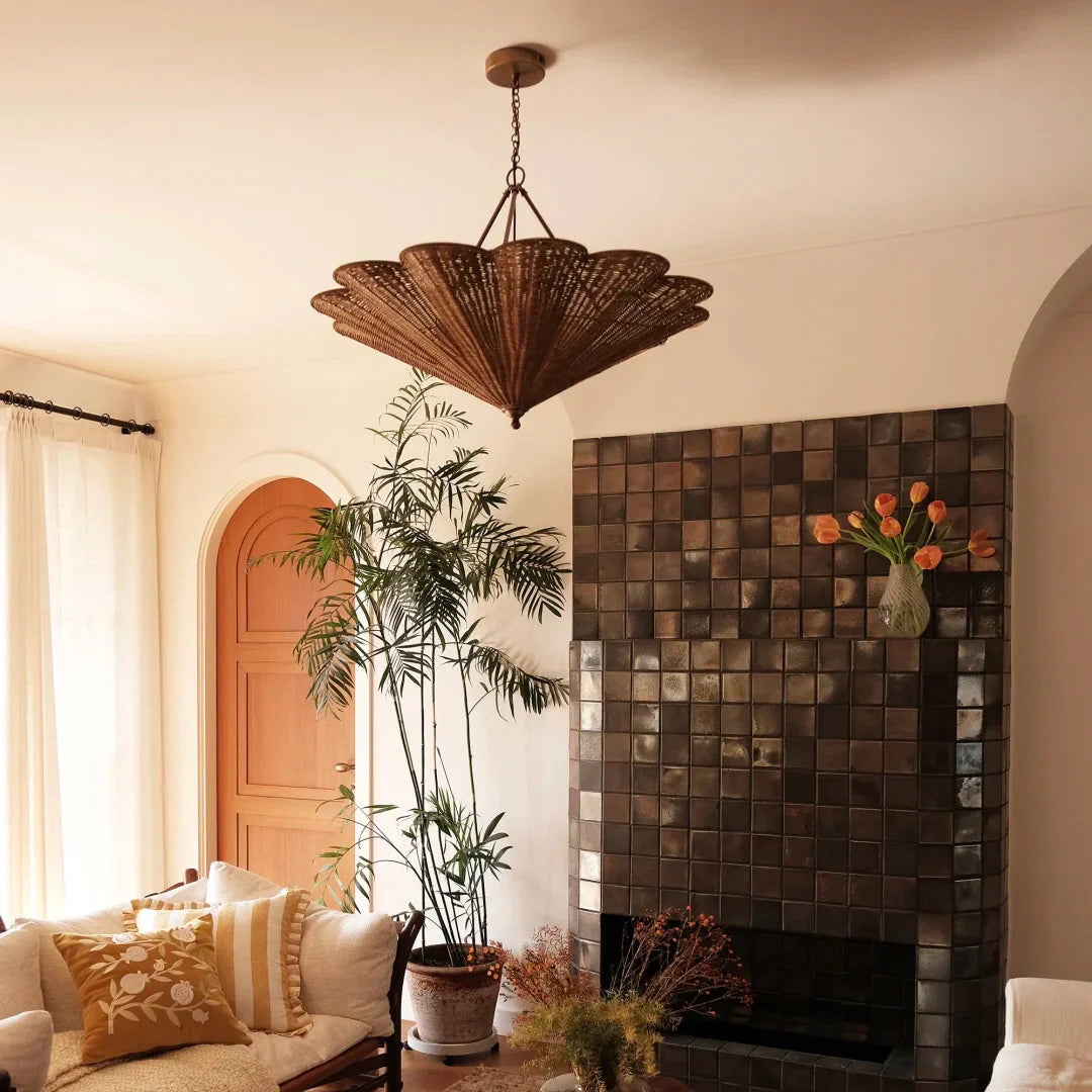 Rattan umbrella pendant light with umbrella-shaped shade hanging from brass chain