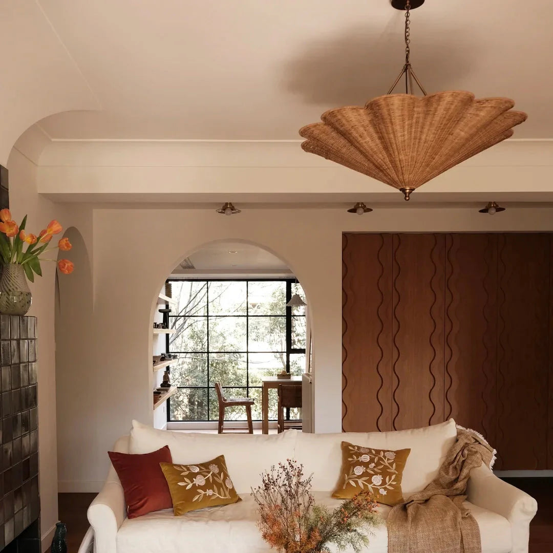 Rattan umbrella pendant light centered over living room, woven umbrella shade