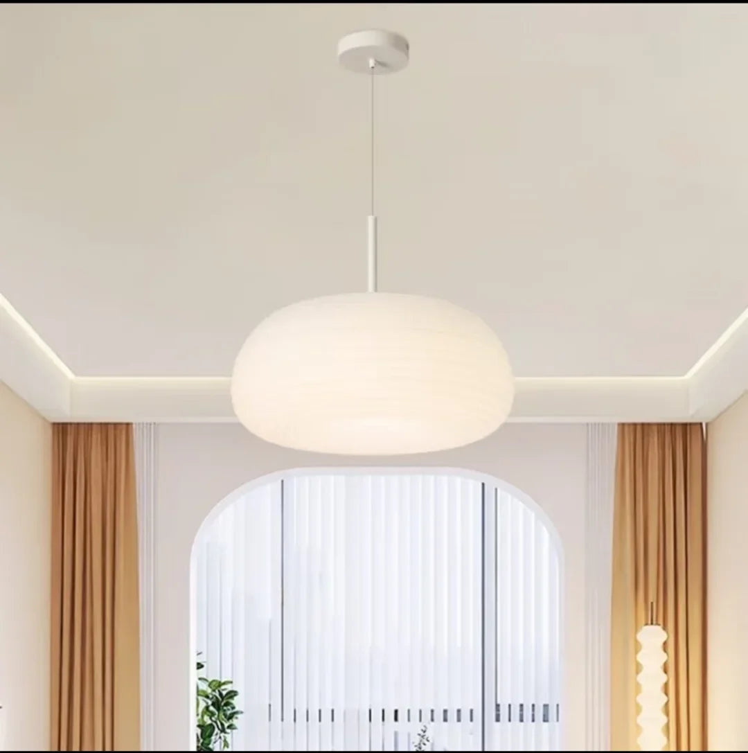 Soft white ribbed pendant lamp with round shade hanging from ceiling
