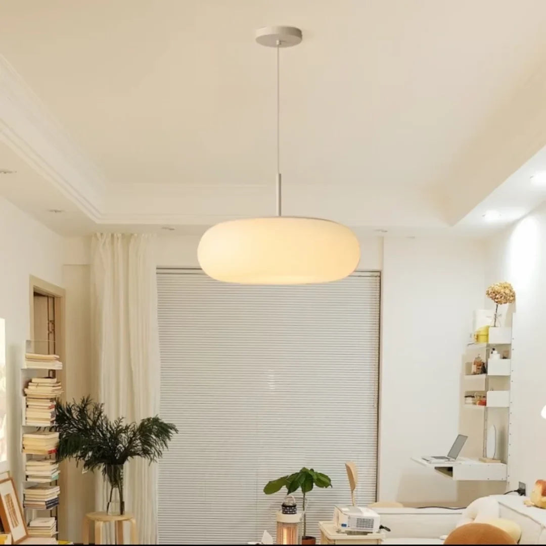 Minimal pendant light with oval ribbed white shade and white ceiling mount