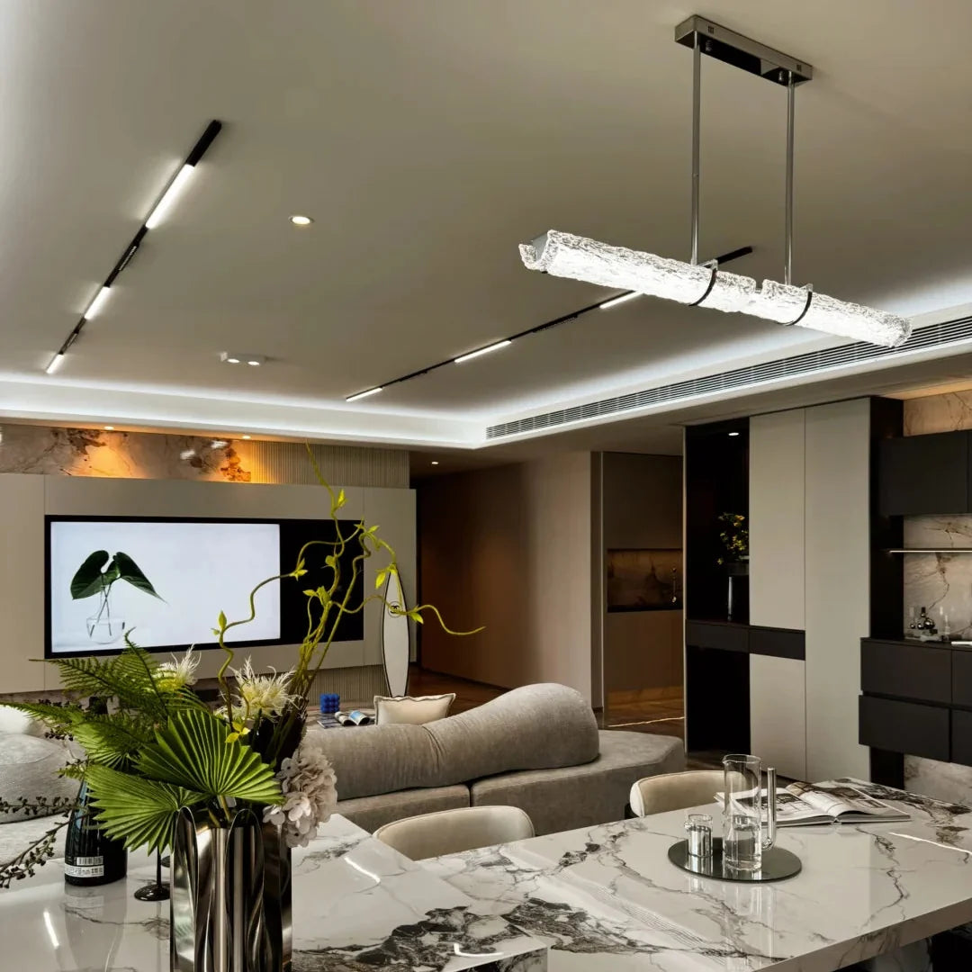 Overhead linear pendant light with textured glass tube and rectangular metal canopy