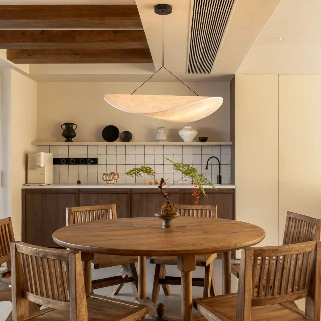 Oval paper pendant light with warm beige shade and black mounting