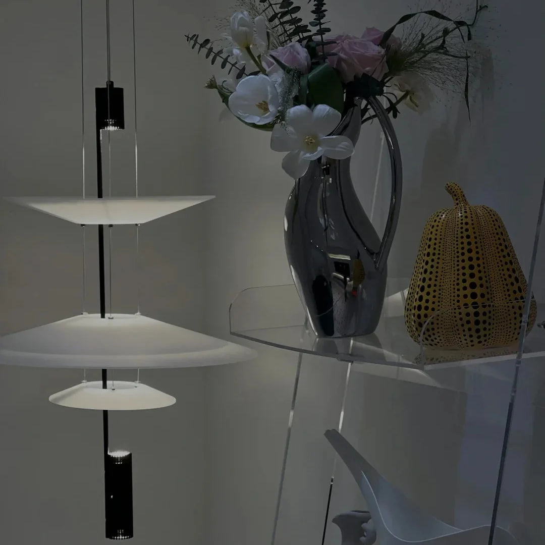 Stacked disc chandelier with white shades and black metal rods