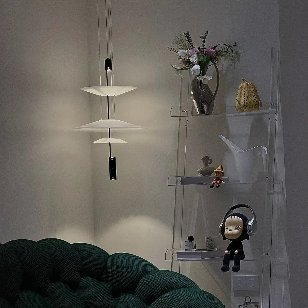 Stacked disc chandelier with white shades and black vertical hanging rods