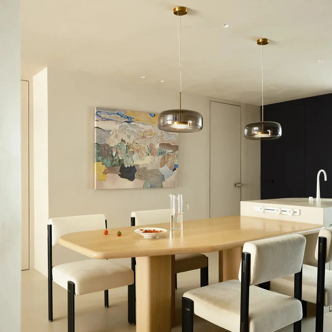 Glass dome pendant lights with brass caps and curved glass shades