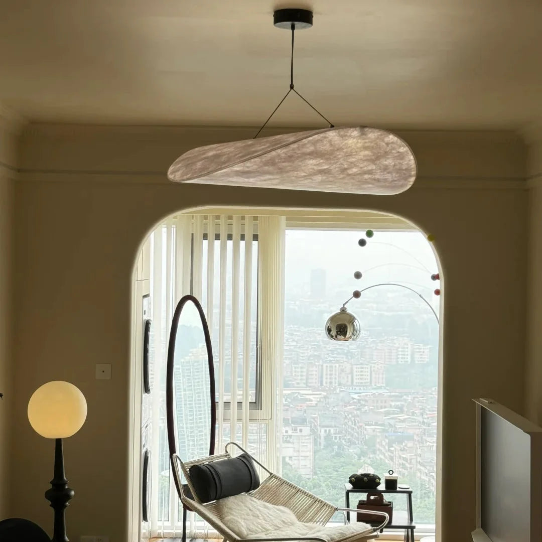 Oval paper pendant light with textured light-beige shade and black cord