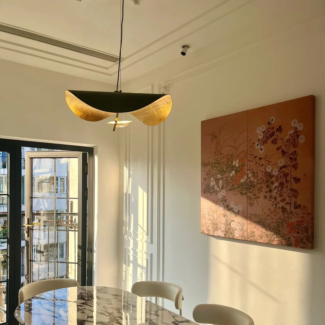 Black and gold foil disc pendant light with two curved gold-toned metal sections