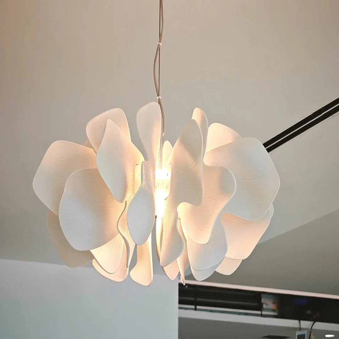 White ceramic petal chandelier with layered shades and bright central illumination