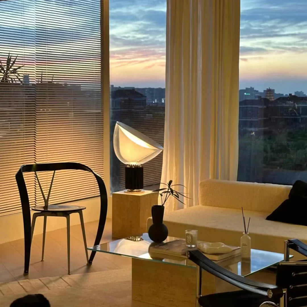 Dome glass saucer table lamp with clear dome shade and black ribbed base, lit