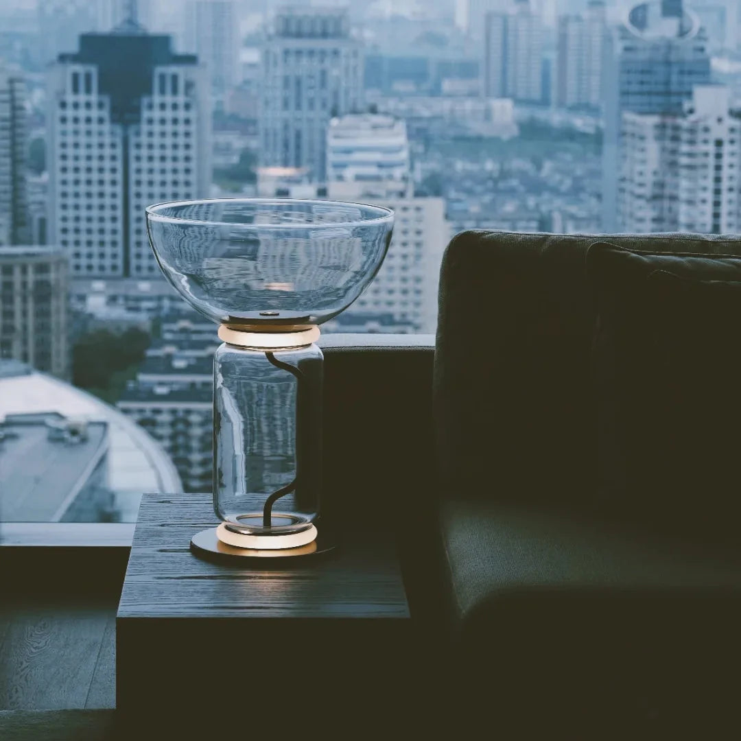 Glass floor lamp with blue-tinted glass bowl shade and clear stem, black base.