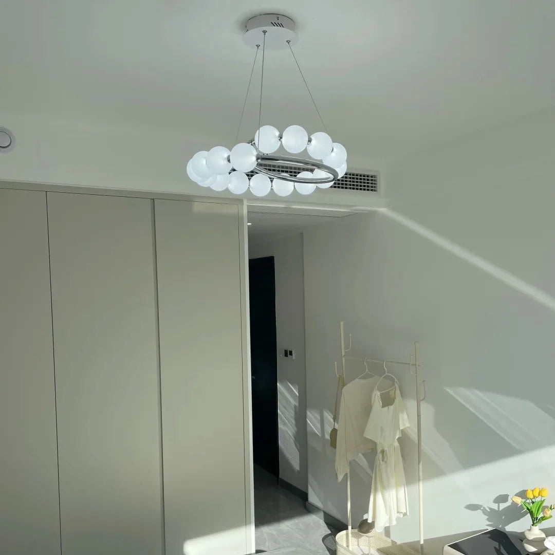 Pearl chandelier overhead with white globe shades clustered in a spiral metal frame