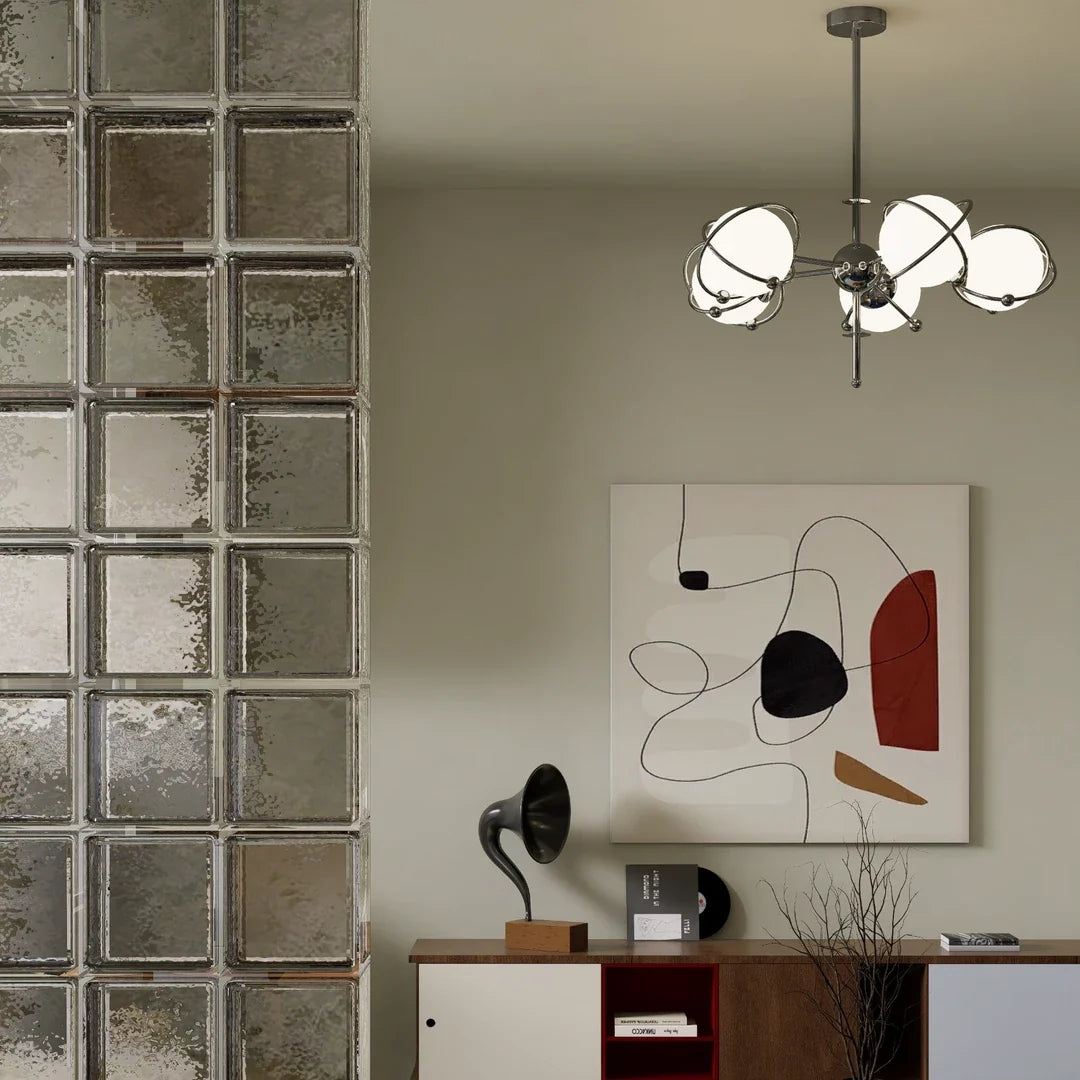 Orbit-style chandelier with round opal glass shades and chrome metal arms in a room setting