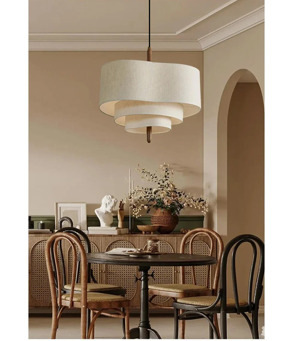 Round layered linen pendant light with beige drum shade and wood connector