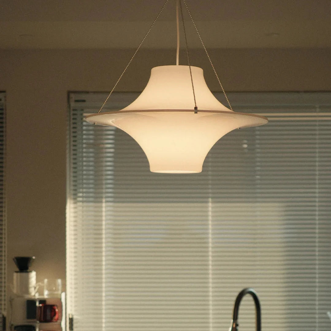 White disc pendant light suspended by two thin cords