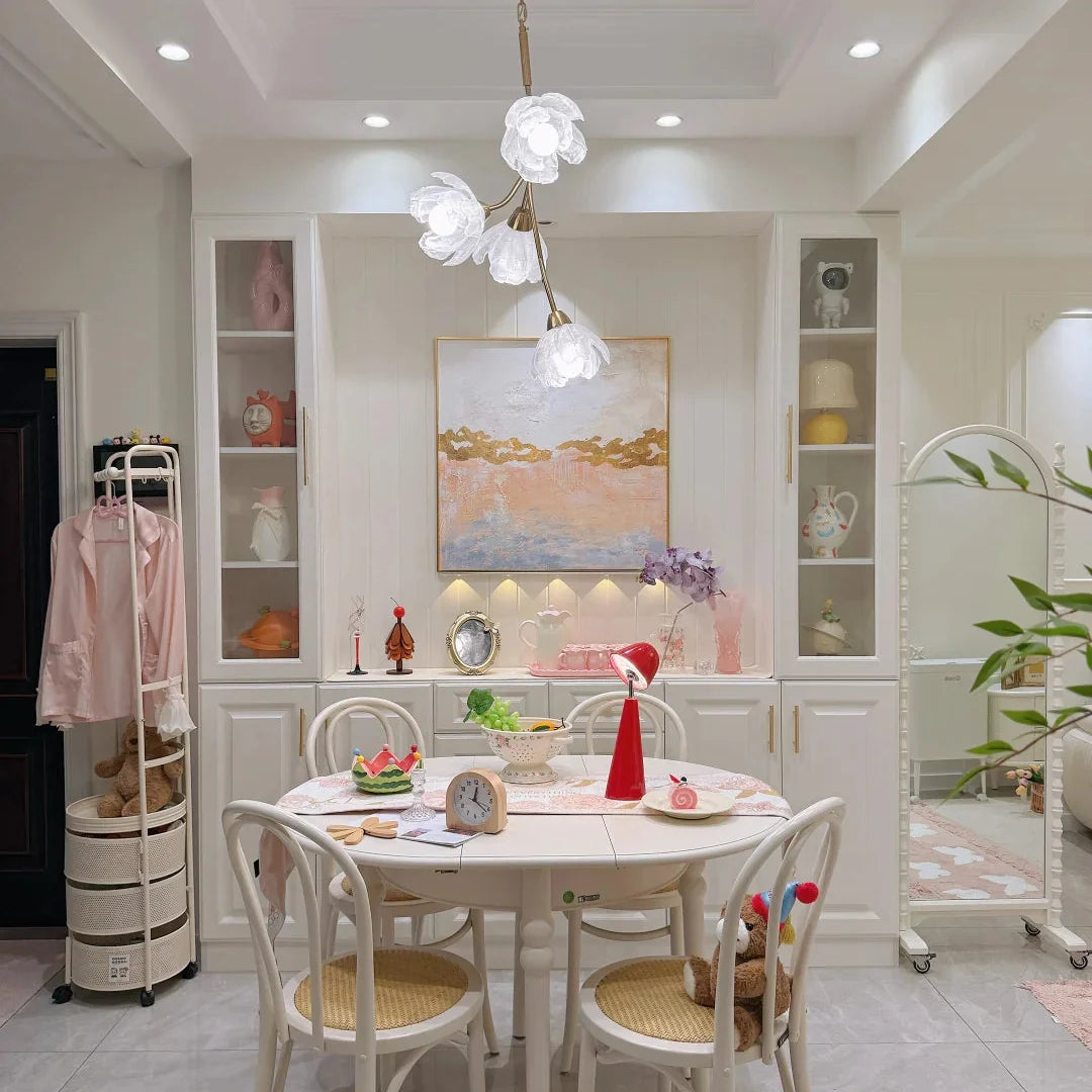 Gold floral branch chandelier with white frosted flower shades hanging from chain