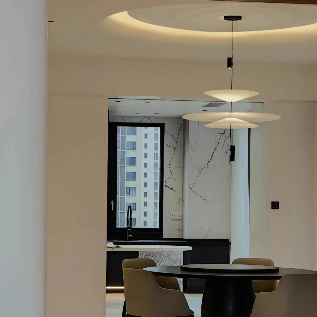 Stacked disc chandelier with multiple white disc shades and black hanging stems
