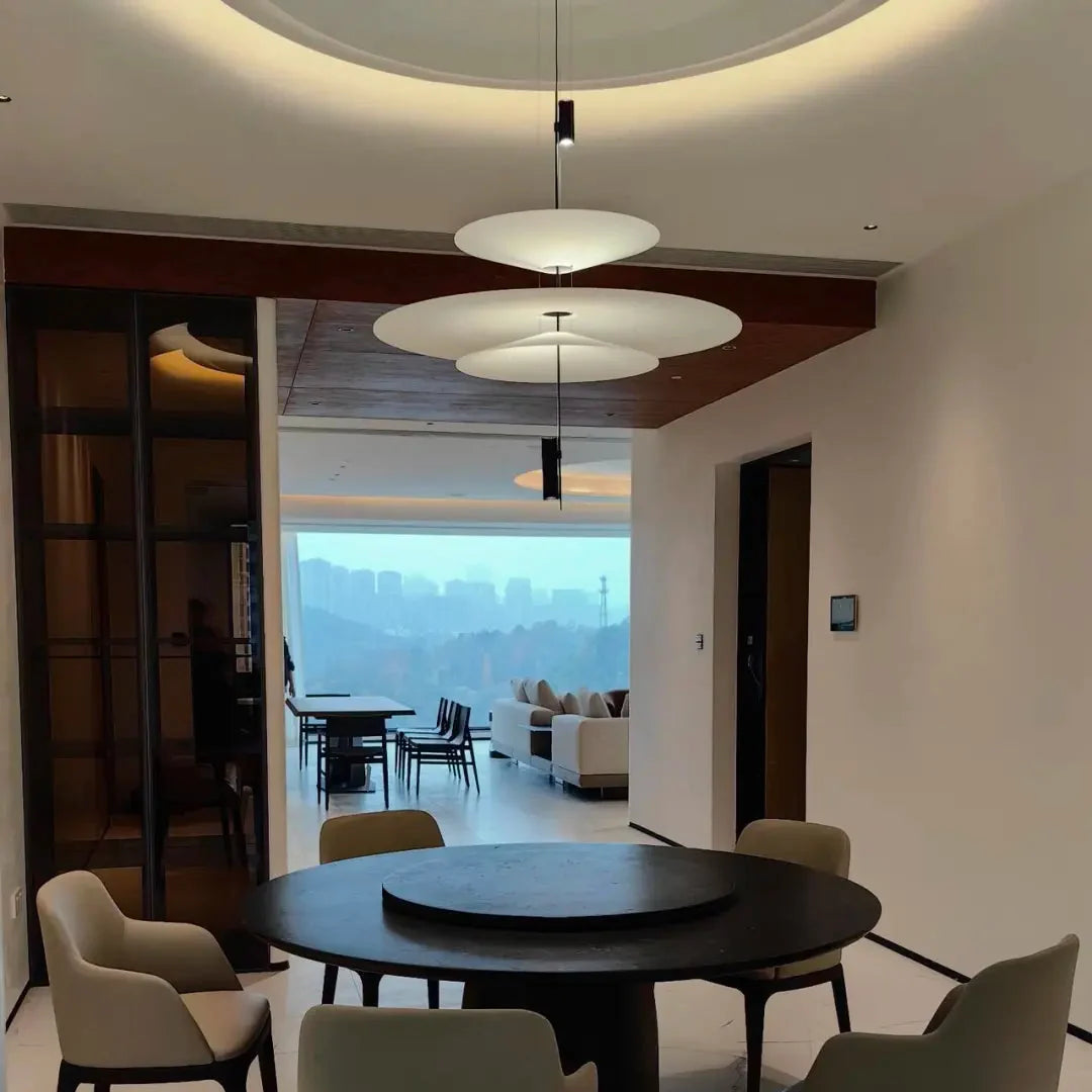 Stacked disc pendant chandelier with white disc shades on black hanging stems