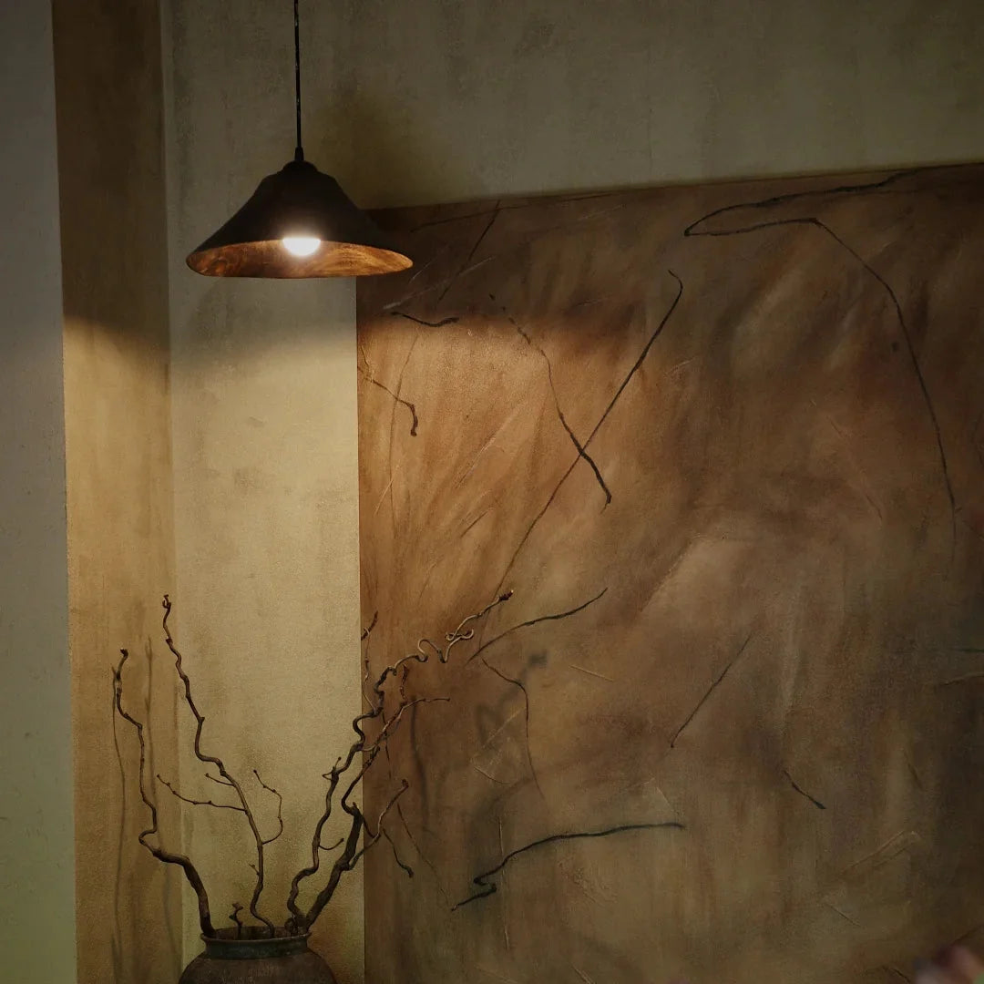 Cone wood pendant light with dark wood cone shade, warm glow from hanging cord
