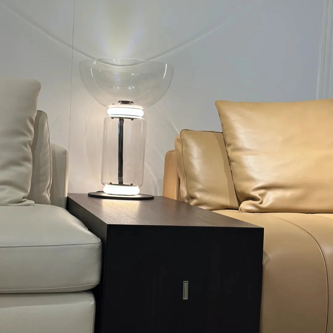 Glass floor lamp with clear bowl shade, chrome column, and black base.