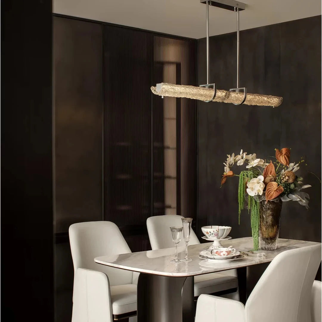 Linear pendant light with frosted textured glass bar and chrome hanging hardware