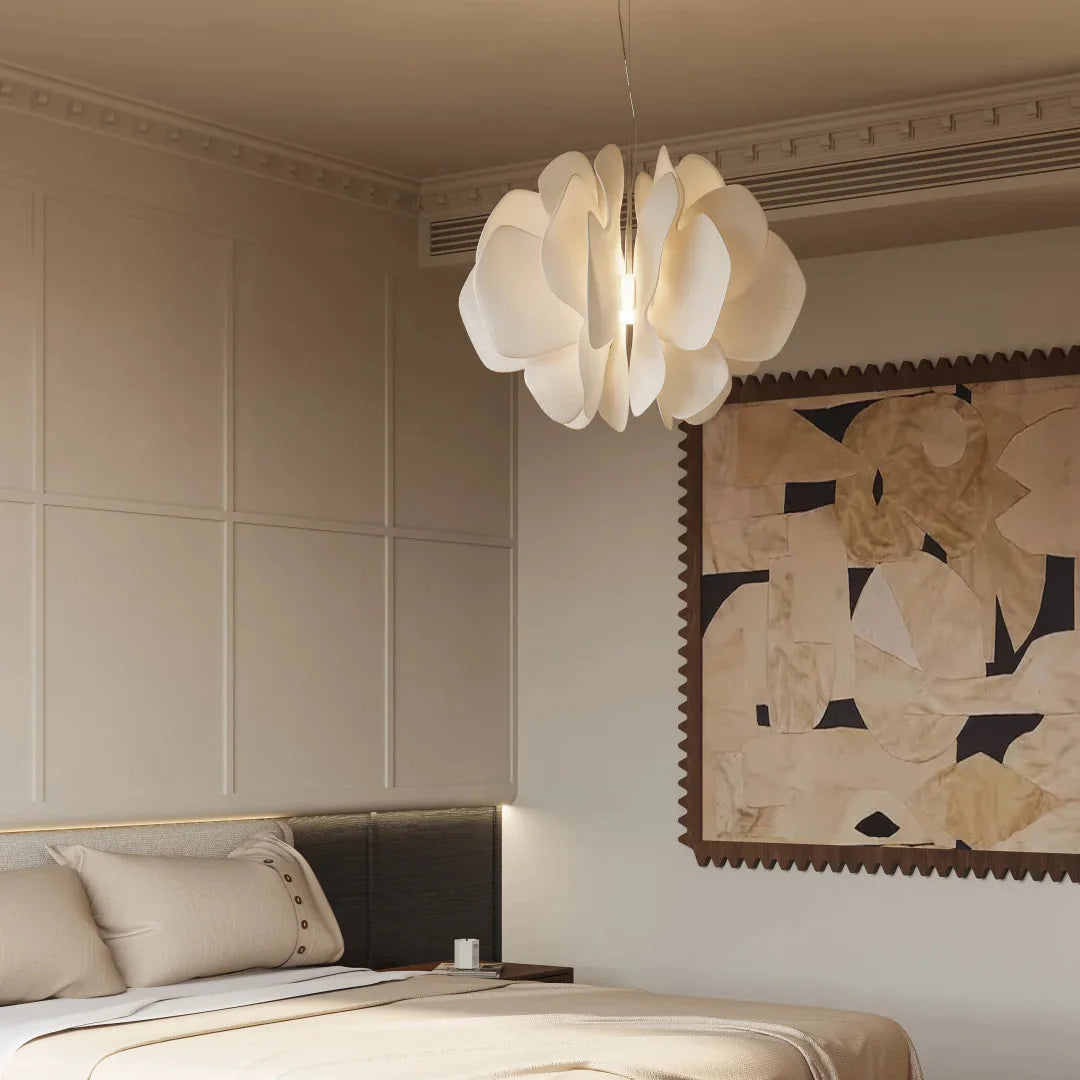 White ceramic petal chandelier with curved petal shades and warm light glow