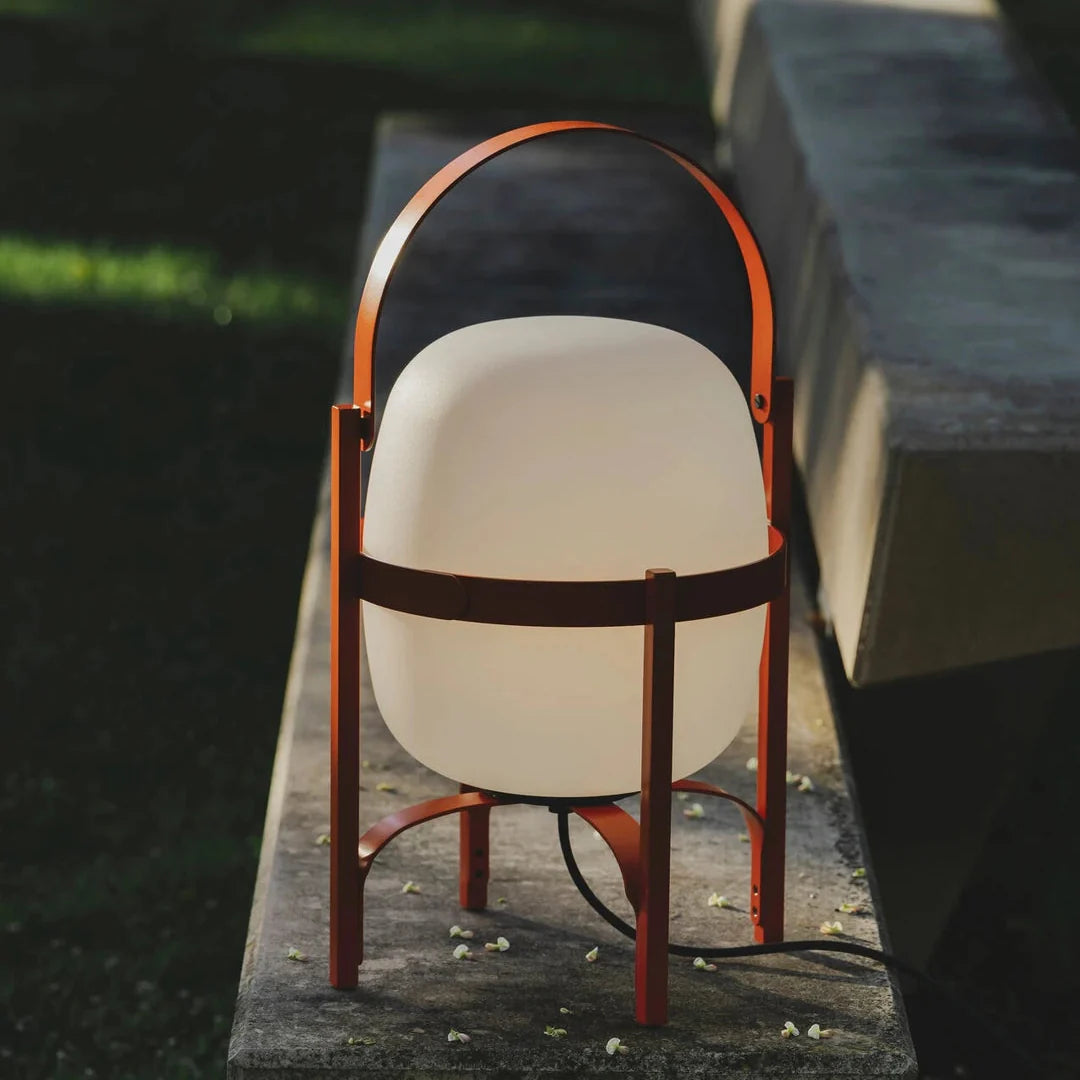 Outdoor table lamp with frosted globe shades and dark arched metal-and-wood frame