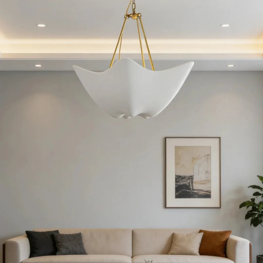 Chalk-white plaster chandelier with five petal shades hanging from gold chain