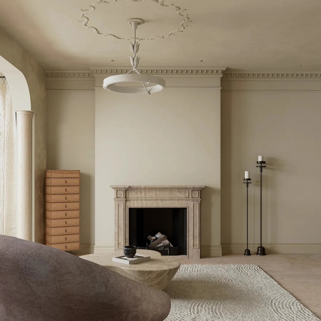White circular ceiling chandelier with sculpted stem and ring shade above fireplace wall
