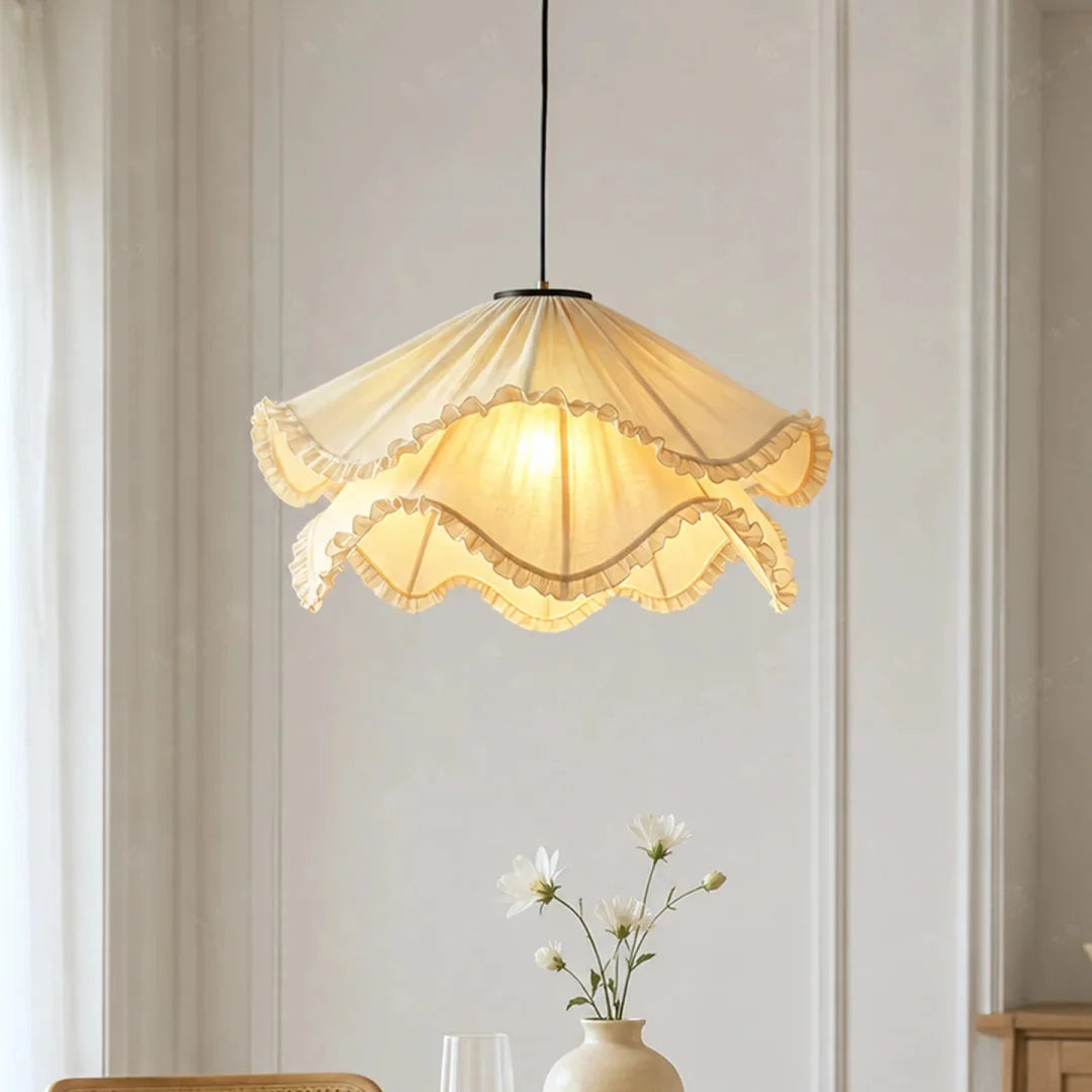 Cream pleated fabric pendant light with layered ruffled trim and black hanging cord