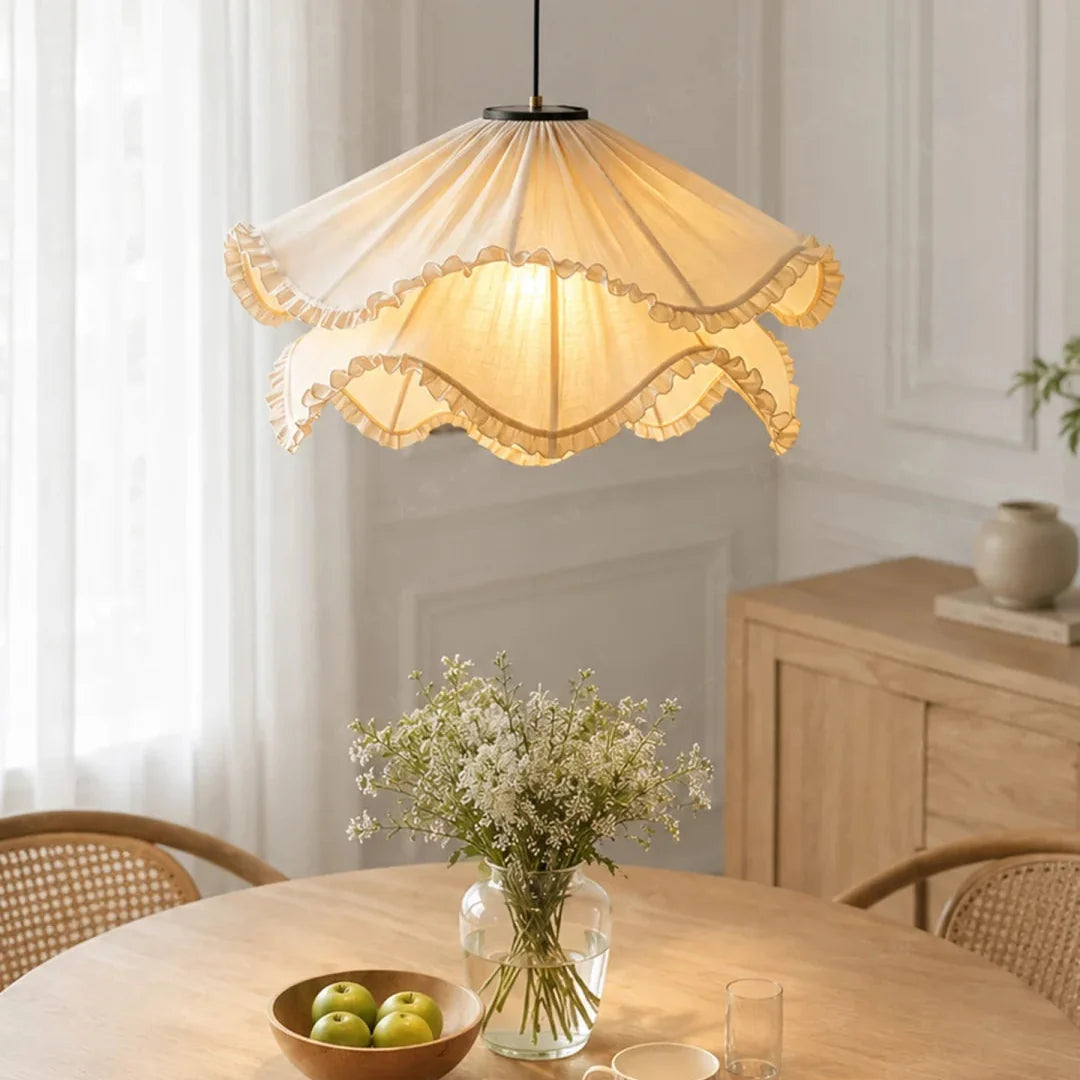 Cream pleated fabric pendant light with layered ruffle edges and warm glow