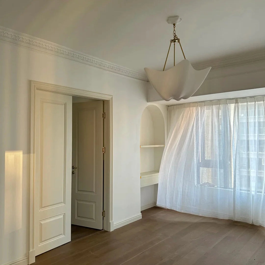 Chalk white plaster chandelier with sculpted petal diffuser and brass ceiling canopy